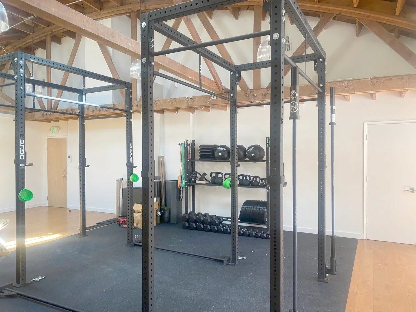 Squat racks and free weights in the clinic’s gym area